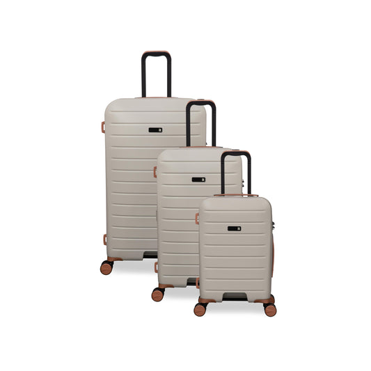Set of three beige suitcases with black handles and wheels on a white background