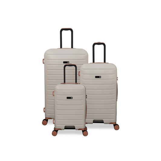 Set of three beige suitcases of different sizes on a white background