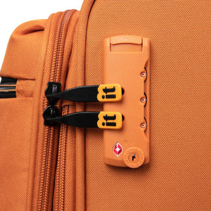 Close-up of an orange suitcase with a lock mechanism