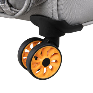 Close-up of a suitcase wheel with orange tire and black rim on a gray background