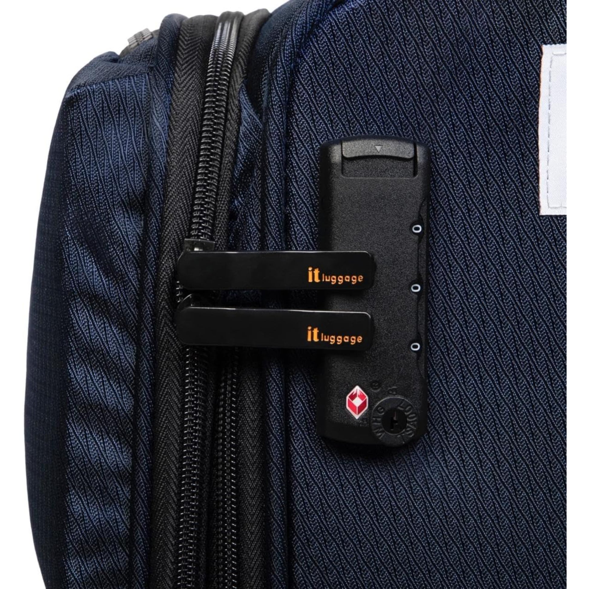 it luggage Close-up of a navy blue suitcase with a black handle and visible 'it luggage' branding.