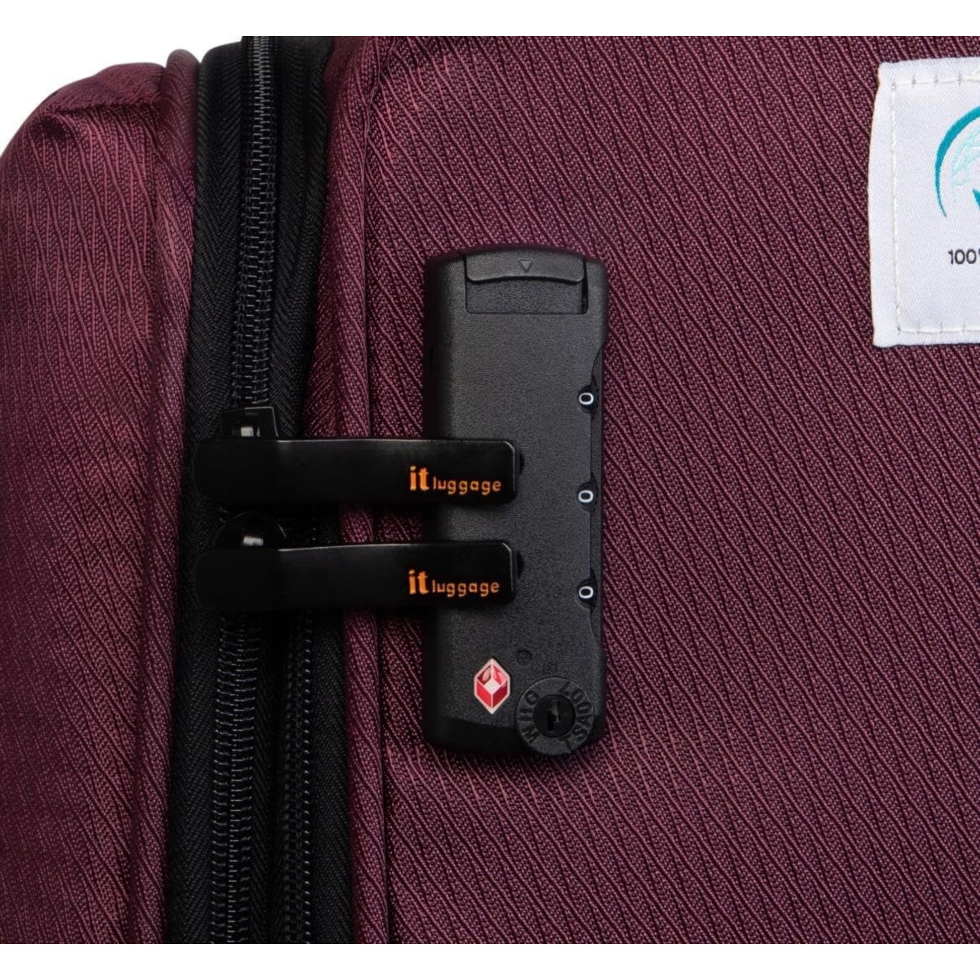 it luggage red Close-up of a suitcase with a black lock and visible brand logo.